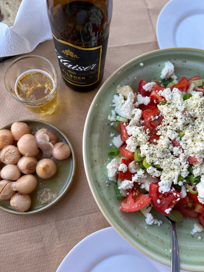 services-01 Colorful Mexican salad, pickled eggs, and beer on a summer table setting.