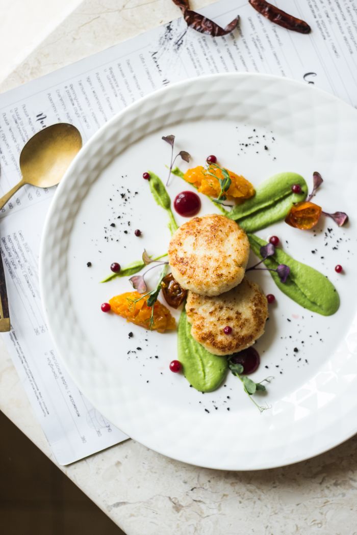 services-01 Elegant dish of seared scallops served with vibrant citrus segments and herb puree.